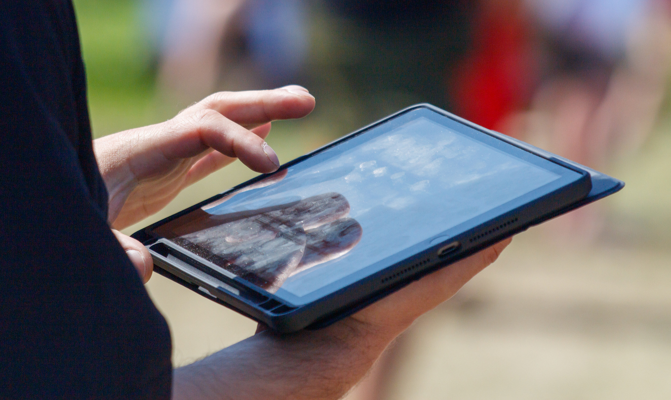 person holding a tablet to conduct a survey